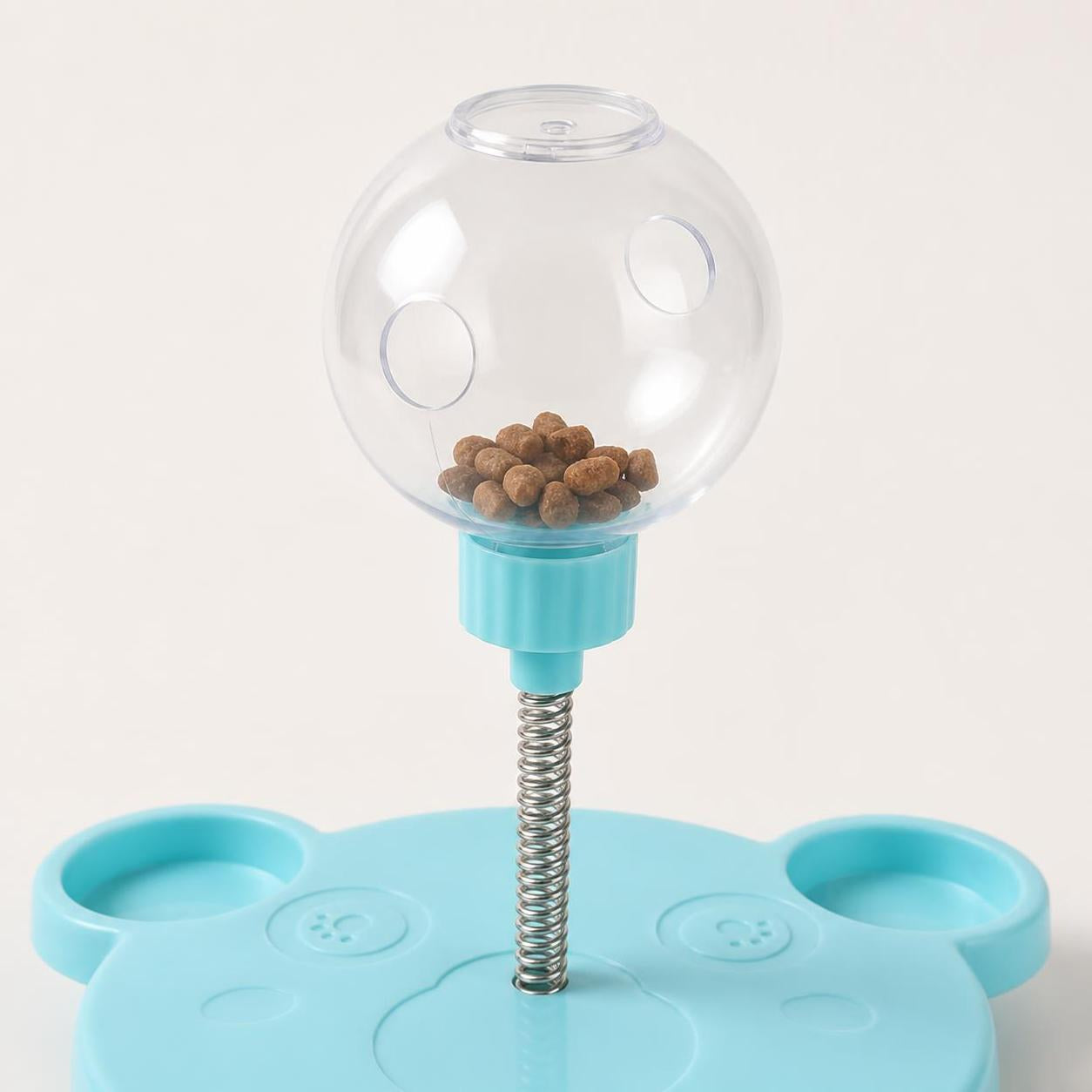 PuzzlePounce clear treat globe with dispensing holes and dry treats inside