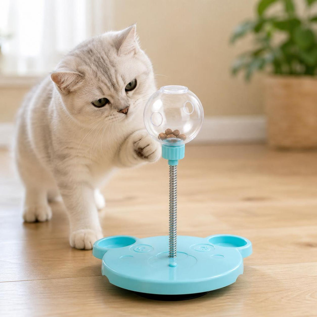 Cat pawing the PuzzlePounce treat puzzle toy on a clean wood floor